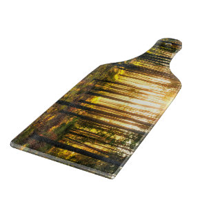 Sun beams shines in pine forest cutting board