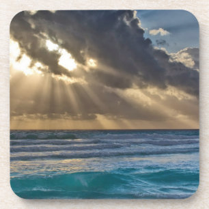 Sun Breaking Through Clouds Over Sea Coaster