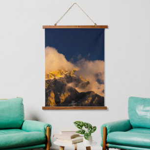 Sun lit mountains covered by clouds hanging tapestry