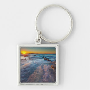 Sun rays illuminate the Pacific Ocean Key Ring