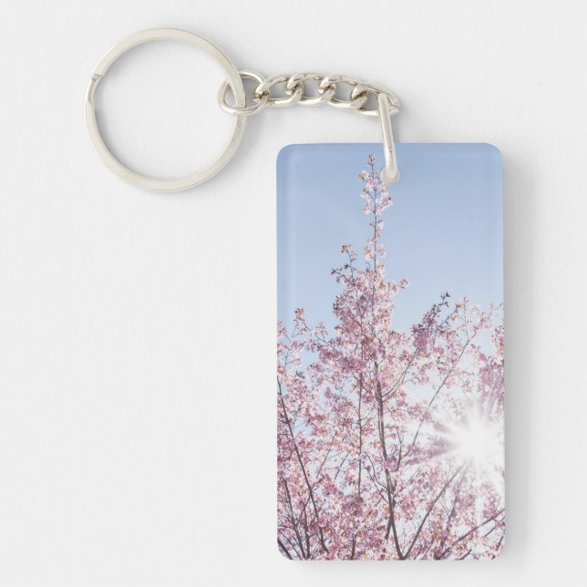 sun rays pass through pink flowers of a wow tree key ring (Front)