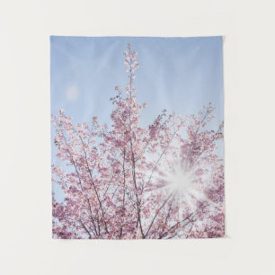 sun rays pass through pink flowers of a wow tree tapestry