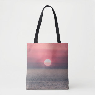 SUN SETTING ON OCEAN HORIZON TOTE BAG