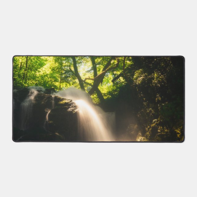Sun shining on a magical waterfall desk mat (Front)