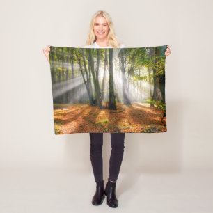 Sunbeams in a misty beech tree forest in autumn - fleece blanket