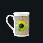 Sunflower on Rustic Wood Bone China Mug<br><div class="desc">On this enchanting bone china mug are neon shades of green and yellow sunflowers on a rustic wood planks backdrop creating a country charm to spice up any kitchen decor.</div>