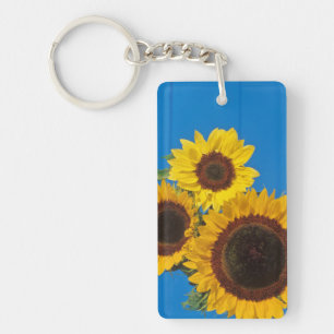 Sunflowers against blue fence key ring