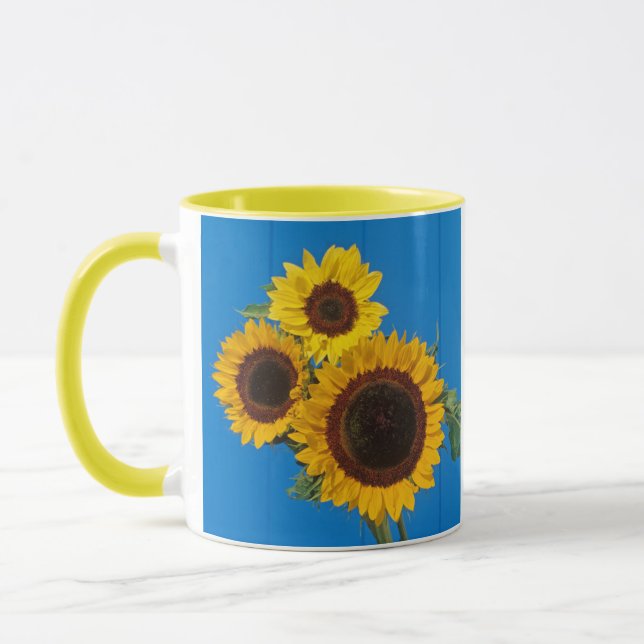Sunflowers against blue fence mug (Left)
