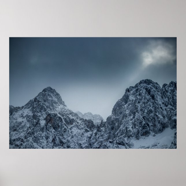 Sunlight and dark clouds over snowy mountains poster (Front)