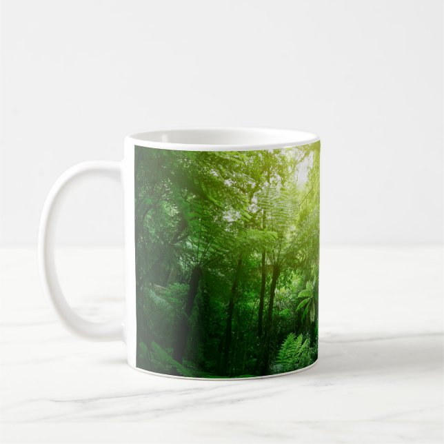 Sunlit tree canopy in tropical jungle  coffee mug (Left)