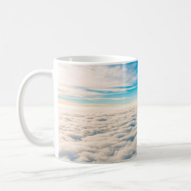 Sunrise above clouds from aeroplane window coffee mug (Left)