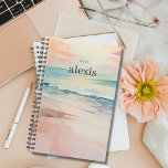 Sunrise Beach | Pretty Personalised Yearly Planner<br><div class="desc">Stay organised and inspired with our customisable planner featuring a tropical beach design with a soft sunrise beach scene on both the front and back covers. Personalise it with your name and the year for a planner that's uniquely yours. With ample space for scheduling, note-taking, and goal-setting, this planner is...</div>