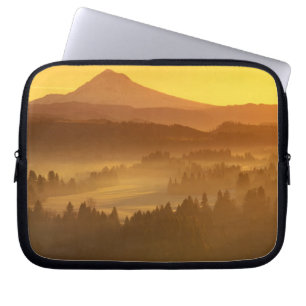 Sunrise orange colours the fog in the valley in laptop sleeve