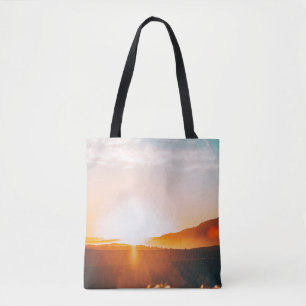 sunrise over a mountain tote bag