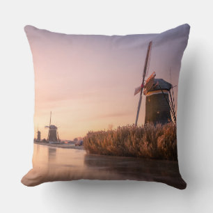 Sunrise over frozen river with windmills and reeds cushion