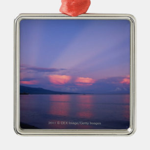 Sunrise over sea metal ornament