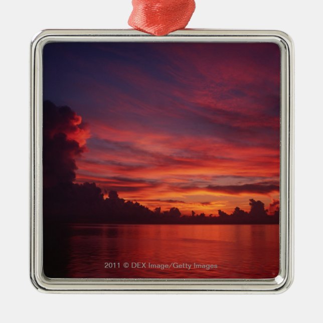 Sunset at sea with dark clouds metal ornament (Front)