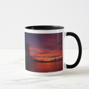 Sunset at sea with dark clouds mug