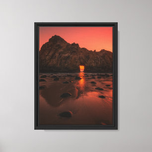 Sunset Glow Through Rock Arch on Ocean Shore Canvas Print