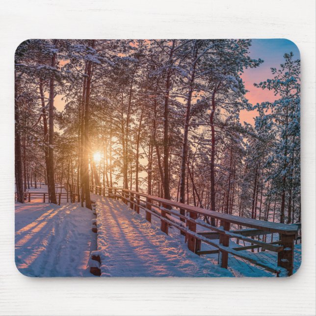 Sunset in snowy pine forest with sun ray mouse pad (Front)