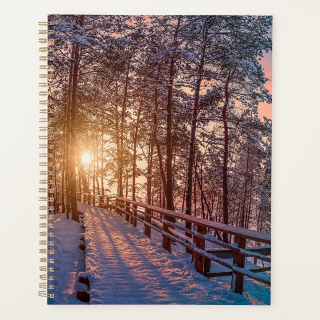 Sunset in snowy pine forest with sun ray planner (Front)