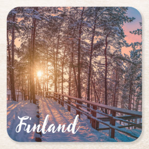 Sunset in snowy pine forest with sun ray square paper coaster