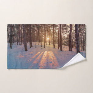 Sunset in snowy winter pine forest hand towel