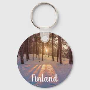 Sunset in snowy winter pine forest key ring