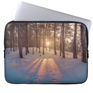 Sunset in snowy winter pine forest laptop sleeve