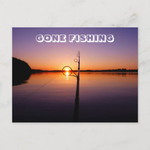 Sunset on a summer lake seen through a fishing rod postcard
