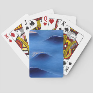 Sunset on rocks protruding through foamy water playing cards