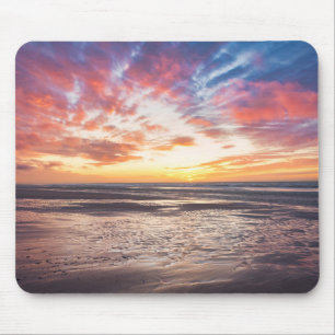 Sunset over beach and sea mouse pad