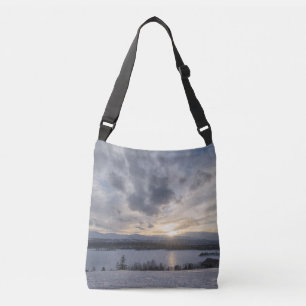 Sunset over frozen lake crossbody bag