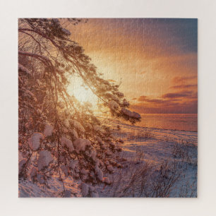 Sunset over sea and snowy pine tree jigsaw puzzle
