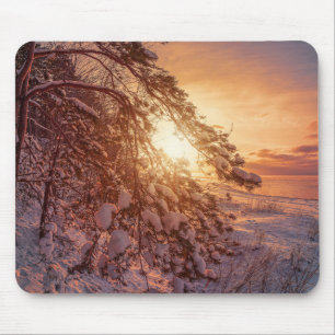 Sunset over sea and snowy pine tree mouse pad