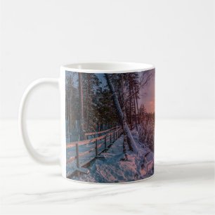 Sunset over snow sea coast coffee mug