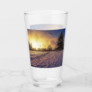 Sunset over snowy winter park glass
