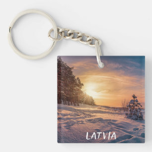 Sunset over snowy winter sea coast key ring