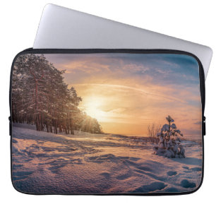 Sunset over snowy winter sea coast laptop sleeve