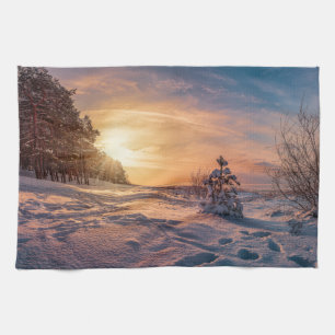 Sunset over snowy winter sea coast tea towel