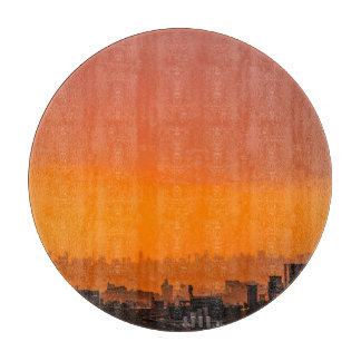 Sunset over the city cutting board