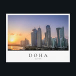 Sunset over the city of Doha, Qatar Postcard<br><div class="desc">Photo postcard of a colourful sunset over the skyline with the skyscrapers on the Corniche in the city centre of Doha,  capital of the Gulf country Qatar with a white edge and the text 'Doha,  Qatar'.</div>