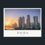 Sunset over the city of Doha, Qatar Postcard<br><div class="desc">Photo postcard of a colourful sunset over the skyline with the skyscrapers on the Corniche in the city centre of Doha,  capital of the Gulf country Qatar with a white edge and the text 'Doha,  Qatar'.</div>