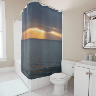 Sunset over the ocean breaking through the clouds shower curtain