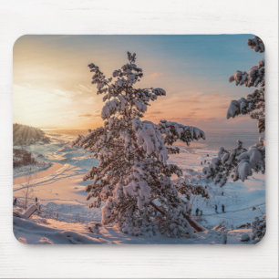 Sunset over winter snowy sea coast mouse pad