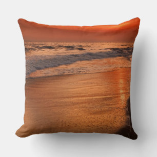 Sunset reflections off clouds and ocean shore cushion
