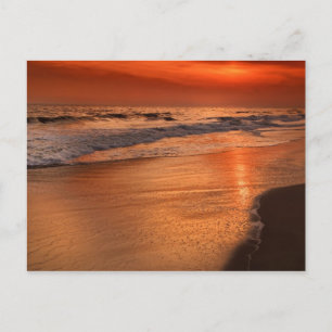 Sunset reflections off clouds and ocean shore postcard