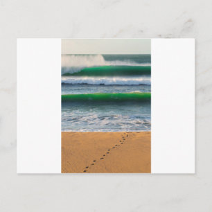 Surfer footprints on sand beach and green waves postcard