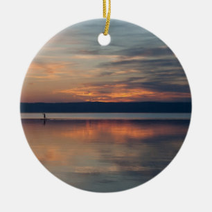 Surfer rowing to shore ceramic ornament