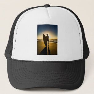 Surfer silhouette during sunrise trucker hat